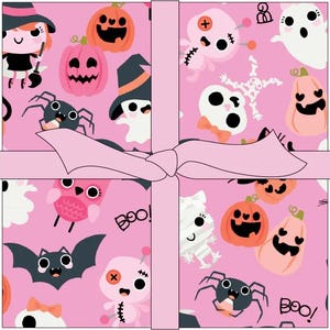 May include: A square gift box wrapped in pink paper featuring a repeating pattern of Halloween icons including orange and pink jack-o'-lanterns, ghosts, spiders, bats, skulls, and voodoo dolls, tied with a light pink ribbon in a cross pattern.