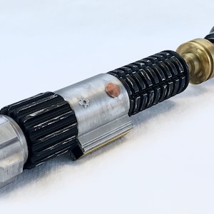 May include: A disassembled lightsaber with a silver and black handle, a brass connector, and a silver emitter. The lightsaber is on a white surface.