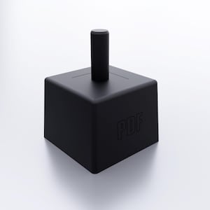 May include: A black cube-shaped object with a cylindrical post extending upwards. The letters "PDF" are subtly embossed on one side. The object is set against a white background, creating a minimalist aesthetic.