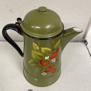 May include: Green enamel coffee pot with a black handle and a lid. The pot has a painted design of strawberries and leaves.
