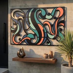 May include: A large, abstract metal wall art piece with a black frame and colorful, flowing shapes in teal, orange, and blue. Below, a wooden shelf displays a bronze sculpture and two ceramic vases. A potted plant is on the right.