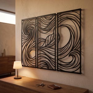 May include: A three-panel black metal wall art set featuring intricate, flowing, wave-like cutouts. The design consists of continuous, swirling lines that create a dynamic, abstract pattern across the rectangular frames mounted on the wall.