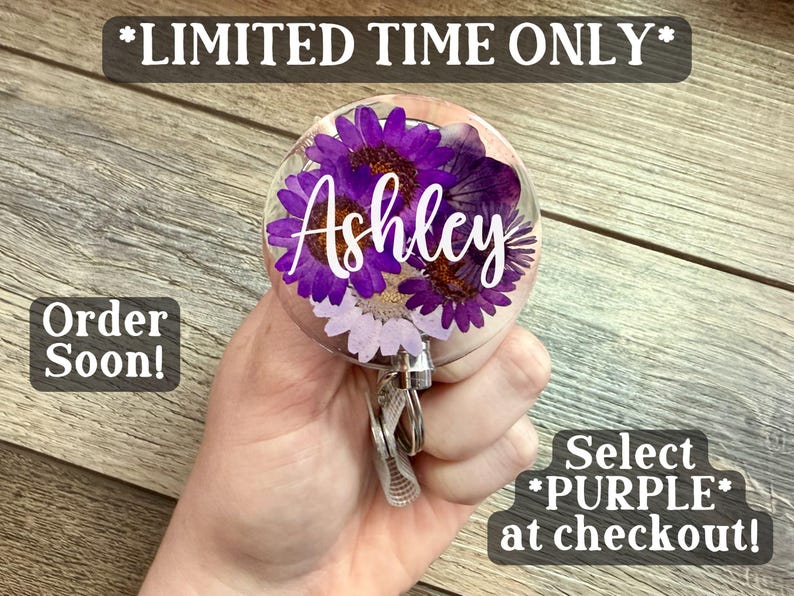 May include: A clear, round badge reel with purple flowers and the name "Ashley" in white script. The text "*LIMITED TIME ONLY*", "Order Soon!", and "Select *PURPLE* at checkout!" are also visible.