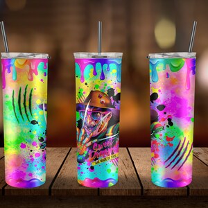 May include: Three stainless steel tumblers with colorful paint splatter designs. The center tumbler features a graphic of Freddy Krueger from the movie "A Nightmare on Elm Street" with the text "Sweet Dreams Are Made of This".