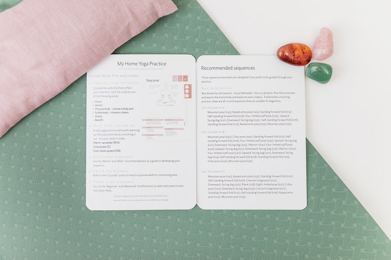 A close-up of a white and green yoga mat with a pink pillow and three crystals. The mat has a text overlay that reads "My Home Yoga Practice" and "Recommended Sequences".