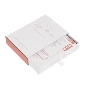 A white box with a pink lid, open to reveal a deck of cards with illustrations of yoga poses. The box has the text "My Home Yoga Practice for yoga practitioners." and the cards have the text "60 Yoga Poses for All Abilities For the mind, body and spirit."