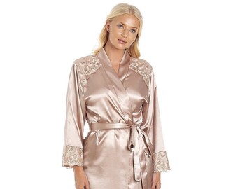 May include: A long, flowing robe in a light beige colour with delicate lace detailing on the shoulders and cuffs. The robe is made of a silky satin material and has a sash tie at the waist.