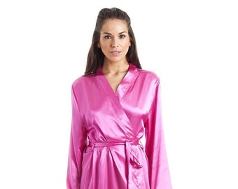 May include: A long, pink satin dressing gown with a tie belt. The gown has long sleeves and a shawl collar.