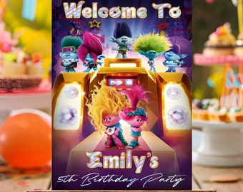 May include: A purple welcome sign with a Trolls World Tour theme. The sign features a large boombox with the Trolls characters dancing in front of it. The text on the sign reads "Welcome to Emily's 5th Birthday Party".