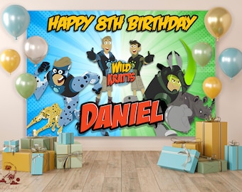 May include: A blue and green birthday banner featuring the Wild Kratts characters, a cheetah, and a rhino. The banner says "Happy 8th Birthday Daniel".