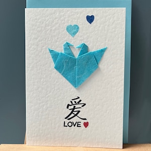 Handgemachtes Origami Liebespaar Kraniche in einer Herz Formation und Liebe Kalligraphie türkis