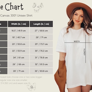 May include: Size chart for a Bella + Canvas 3001 unisex shirt, showing width and length measurements in inches and centimeters for sizes XS to 3XL. The chart includes a model wearing the shirt, illustrating the fit.