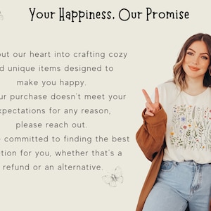 May include: A woman wearing a white t-shirt with a floral print and a brown cardigan. The t-shirt has the text "Your Happiness, Our Promise" and a logo with the text "Forest Fables".