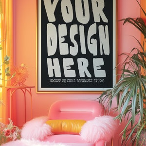 May include: A pink armchair with a fluffy white cushion and a yellow pillow. The chair is in front of a black framed poster with the text "YOUR DESIGN HERE" and the words "MOCKUP BY EMMA RODRIGUEZ STUDIO". The wall is a bright pink color.