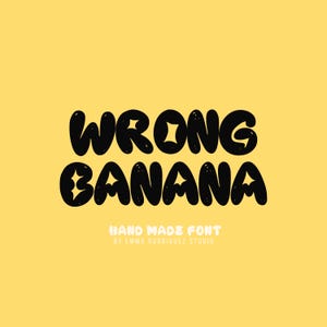 May include: A digital graphic featuring the black text WRONG BANANA in a rounded, bubbly typeface with small star accents on a solid yellow background. Below the main text, the words HAND MADE FONT BY EMMA RODRIGUEZ STUDIO appear in white.