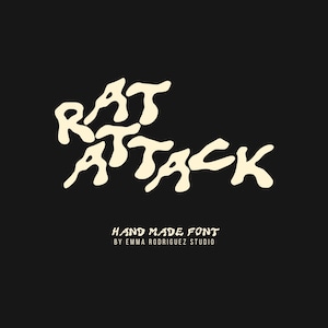 May include: A digital graphic featuring the text RAT ATTACK in a large, cream-coloured, wavy, hand-drawn font against a solid black background. Below this, smaller white text reads HAND MADE FONT BY EMMA RODRIGUEZ STUDIO in a clean sans-serif typeface.