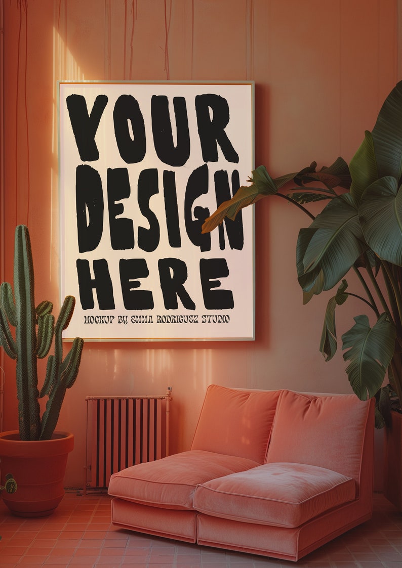 May include: A pink living room with a large framed poster that says "YOUR DESIGN HERE" in black lettering. A cactus plant is in a terracotta pot on the left side of the image. A pink sofa is on the right side of the image.
