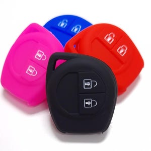 May include: Four silicone key covers in pink, blue, red, and black. Each cover has two buttons with lock icons.