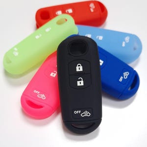 May include: Assortment of silicone key covers in various colours, including red, green, blue, pink, and black. The covers feature a button for "OFF" and a lock icon.