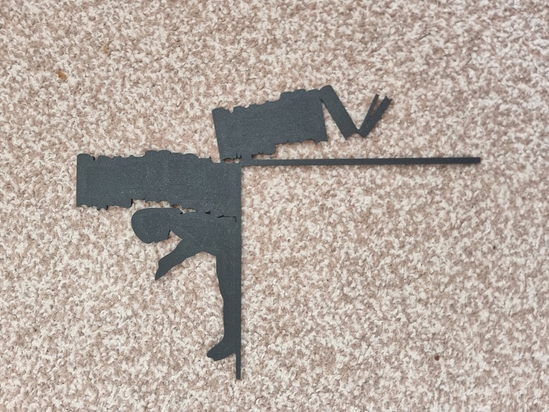 May include: Black silhouette of a person doing a handstand with a black bar across the top. The person is holding a black object in their hands.