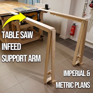 May include: A wooden table saw infeed support arm with wheels. The arm is made of unfinished wood and is designed to support a table saw. The arm is labeled "Table Saw Infeed Support Arm" and "Imperial & Metric Plans".