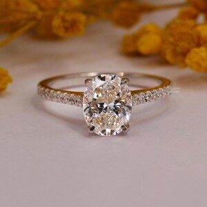 The Light of Your Love: Radiant Oval Cut Moissanite Ring with Petite Pave Moissanite Down the Shank / Pave Set Band for Added Brilliance.