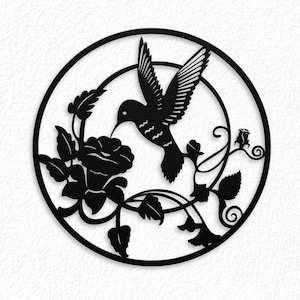 May include: Black metal hummingbird wall art. The silhouette depicts a hummingbird hovering near a flower, surrounded by leaves and vines, all within a circular frame. The design is suitable for indoor or outdoor decor.