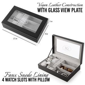 May include: Black vegan leather watch box with a glass top and faux suede lining. The box has four watch slots with a pillow and space for sunglasses. The box measures 13 inches by 8 inches by 3 inches.
