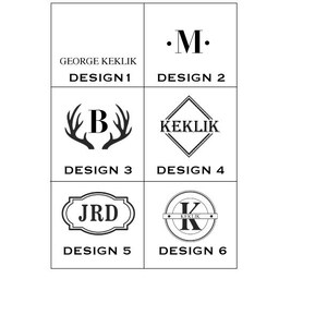 May include: Six different monogram design options for a personalized gift. Designs include a simple initial, a monogram with a deer antler, a monogram with a diamond shape, a monogram with a banner, and a monogram with a circle.
