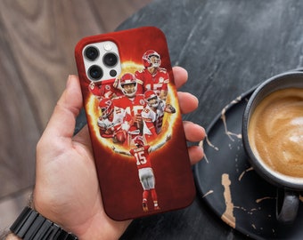 May include: A red, white and gold phone case featuring a graphic of a football player in a red jersey. The player is surrounded by other players in red jerseys. The case has a white camera lens and a black border.
