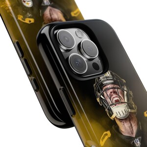 May include: Black phone case featuring a yellow and black image of a football player. The case has a black camera bump with three lenses.