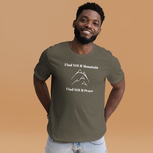 May include: A dark green t-shirt with a white graphic of mountains and the text "Find YOUR Mountain Find YOUR Peace".