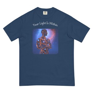 May include: A navy blue t-shirt with a graphic of a person with a galaxy inside them. The text "Your Light Is Within" is printed above the graphic.