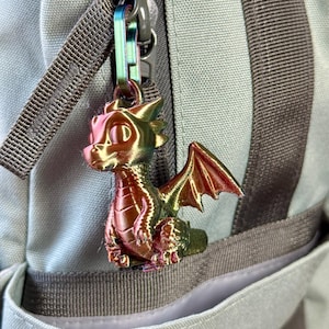 May include: A white ceramic mug with a black handle and the text "But First, Coffee" in a black, handwritten-style font. The mug is on a white surface.