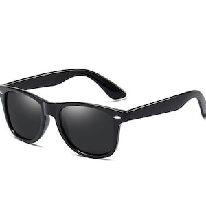 May include: Black sunglasses with a classic, rectangular frame and dark lenses.