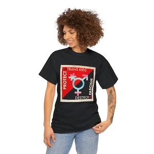 May include: Black t-shirt with a graphic design. The design includes the text "PROTECT TRANS KIDS DESTROY FASCISM" and a transgender symbol in light blue, pink, and black. The t-shirt is a classic crew neck style.