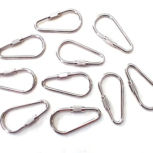 May include: A collection of silver-colored, pear-shaped carabiner clips with screw-lock closures. These metal clips are arranged on a white background, showcasing their design and functionality. Ideal for various crafting and DIY projects.
