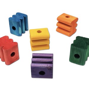 May include: A collection of colorful wooden blocks in blue, yellow, orange, red, green, and purple. Each block has a unique shape and a hole drilled through it. These blocks are likely intended for use as a toy or craft supply.