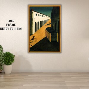 May include: A framed art print depicting a surreal street scene with a figure rolling a hoop. The artwork features a gold frame and the text "GOLD FRAME READY TO HANG". The color palette includes shades of yellow, black, and white.