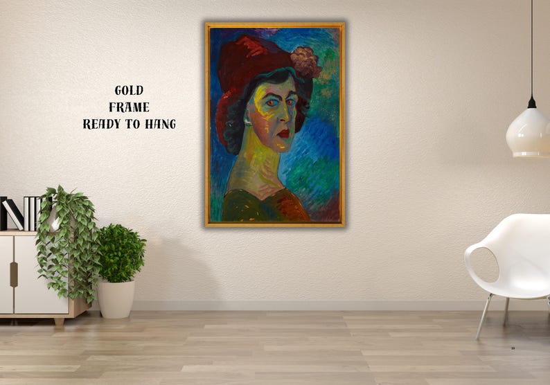 May include: A framed portrait of a person wearing a red hat with a floral accent. The artwork features a colorful palette with blue, green, and yellow hues. The gold frame is ready to hang.