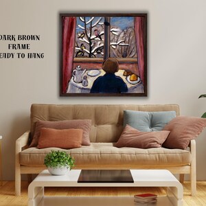 May include: A framed painting depicts a person gazing out a window at a snowy landscape with birds. The artwork features a dark brown frame and is ready to hang. The scene includes a table set with a teapot and plate.
