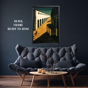 May include: A framed art print depicting a surrealist scene with a figure rolling a hoop down a yellow road. The artwork is in a black frame and is ready to hang. The text "BLACK FRAME READY TO HANG" is visible.