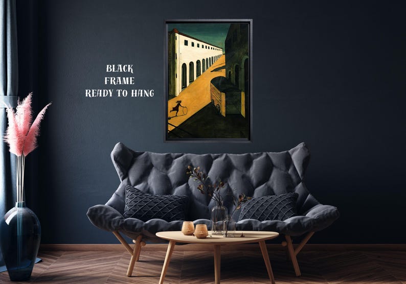 May include: A framed art print depicting a surrealist scene with a figure rolling a hoop down a yellow road. The artwork is in a black frame and is ready to hang. The text "BLACK FRAME READY TO HANG" is visible.