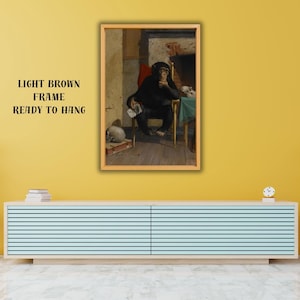 May include: A framed print featuring a chimpanzee seated at a table, dressed in black, with a thoughtful pose. The artwork is set in a room with a fireplace and a skull. The frame is light brown, and the text "LIGHT BROWN FRAME READY TO HANG" is visible.