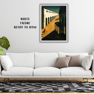 May include: A framed art print depicting a stylized street scene with a figure and cart. The artwork features a white frame and is ready to hang. The text on the wall reads "WHITE FRAME READY TO HANG".