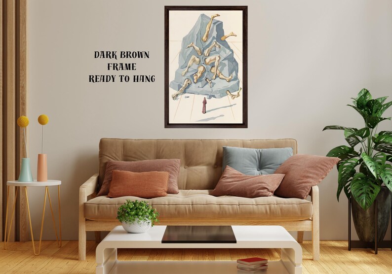 Op de afbeelding: Een ingelijst kunstwerk met een donkerbruine lijst. Het kunstwerk toont een surrealistische sc&egrave;ne van menselijke benen die uit een blauwgrijze rotsformatie komen. Een klein rood figuur staat eronder. De tekst op de muur luidt "DARK BROWN FRAME READY TO HANG."