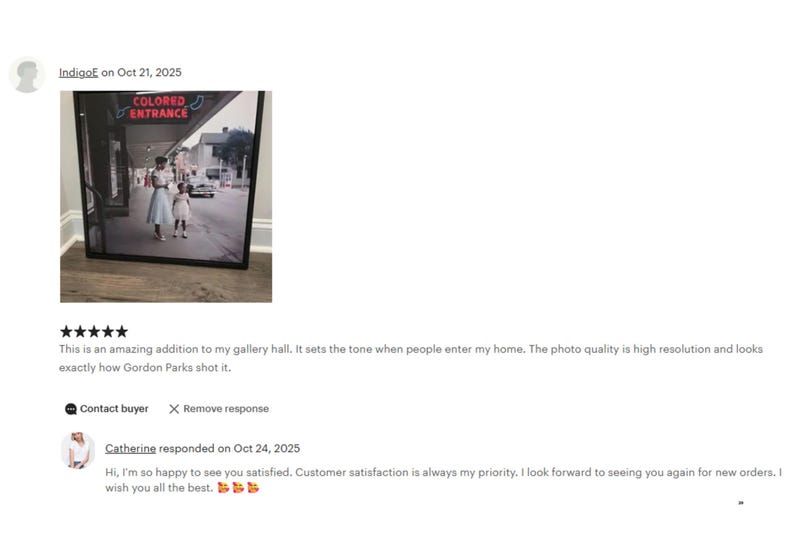 The image is a framed photograph of two people walking on a street, with a sign that reads "COLORED EXTRANGE" above them. The photograph appears to be a high-resolution image of Gordon Parks' work.