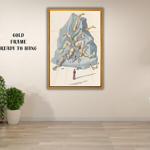 Op de afbeelding: Een ingelijst kunstwerk met een gouden lijst. Het kunstwerk toont een surrealistische sc&egrave;ne van menselijke ledematen die uit een grijze rotsformatie komen. Een klein figuur in rood staat eronder. Tekst op de muur: GOLD FRAME READY TO HANG.