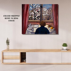May include: A gallery-wrapped canvas print of an interior scene. A person in a blue shirt sits at a table set with a teapot and cake, looking out a window at a snowy landscape. Red curtains frame the window.