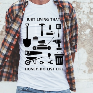 May include: A white t-shirt with a black graphic of various tools and the text "JUST LIVING THAT HONEY-DO LIST LIFE".